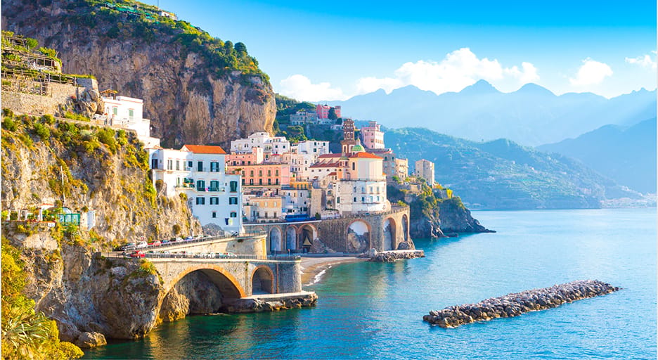 Positano's pastel houses stacked above the sea, seen from the water