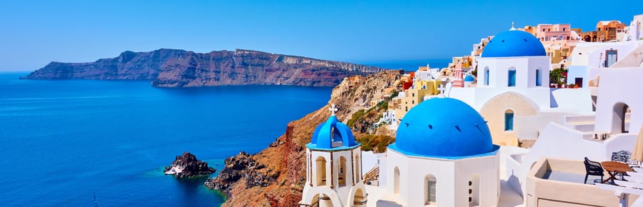 Whitewashed houses above a Greek harbour